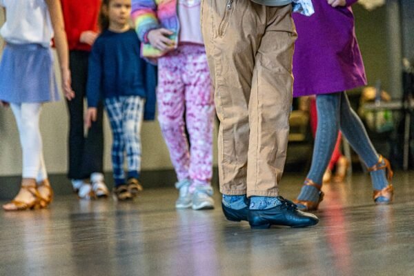 Kids aged 3 and up participating in a free trial dance class at Moonlight Ballroom Dance Studio, learning dance techniques in a bright, welcoming studio environment