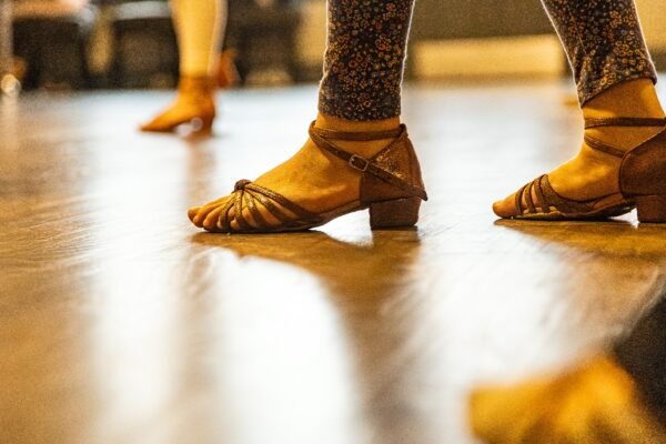 Kids aged 3 and up participating in a free trial dance class at Moonlight Ballroom Dance Studio, learning dance techniques in a bright, welcoming studio environment